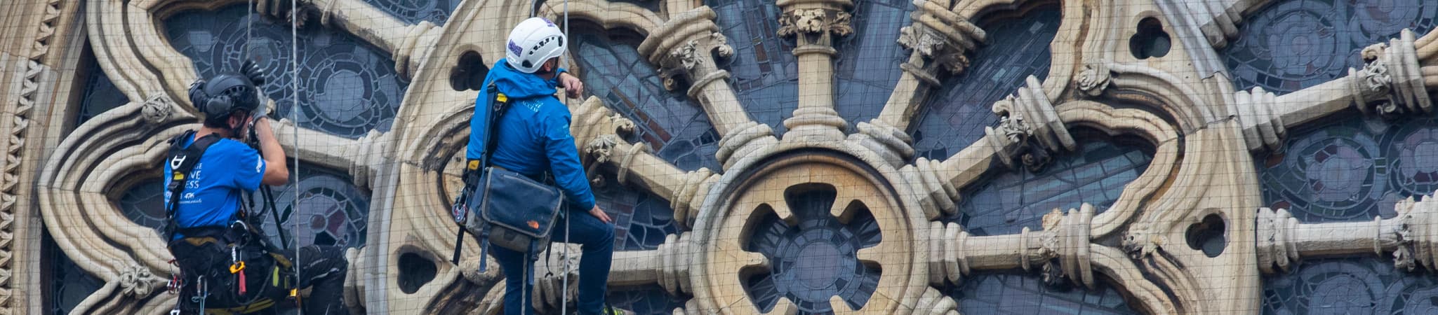Professional workers climbing historical heritage site