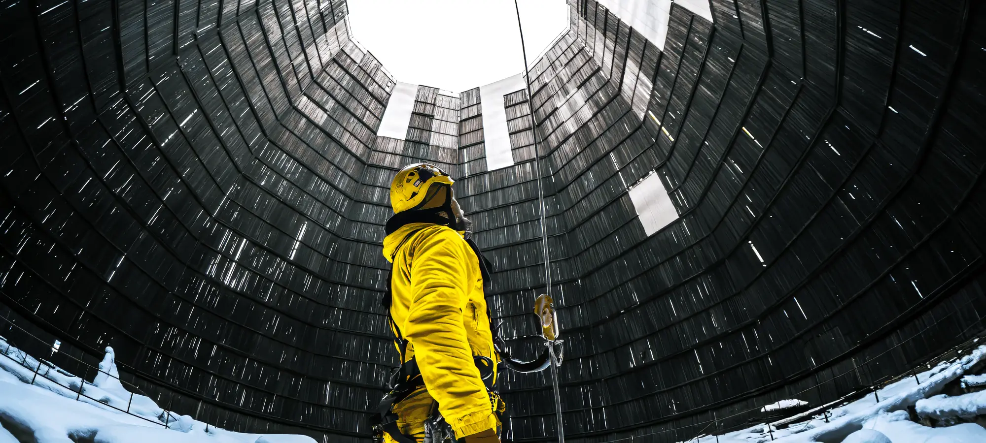Technician in a cooling tower secured by EN 1891 certified static safety ropes for industrial access.