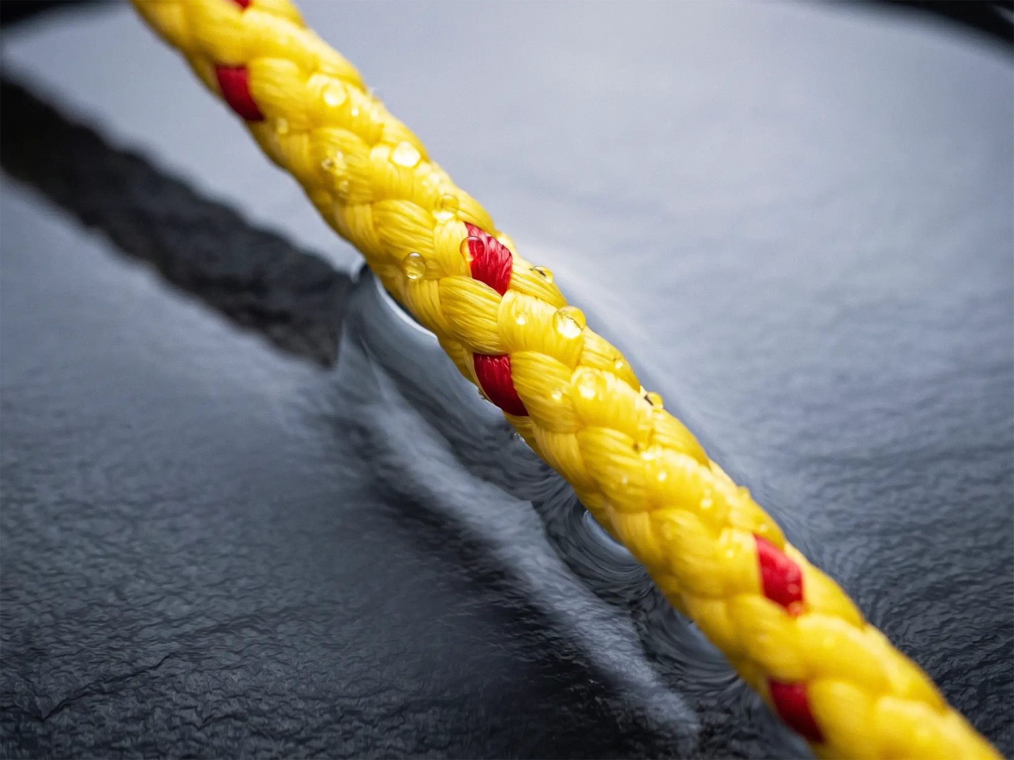 Yellow 8-Plait Multifilament polypropylene rope floating on water surface