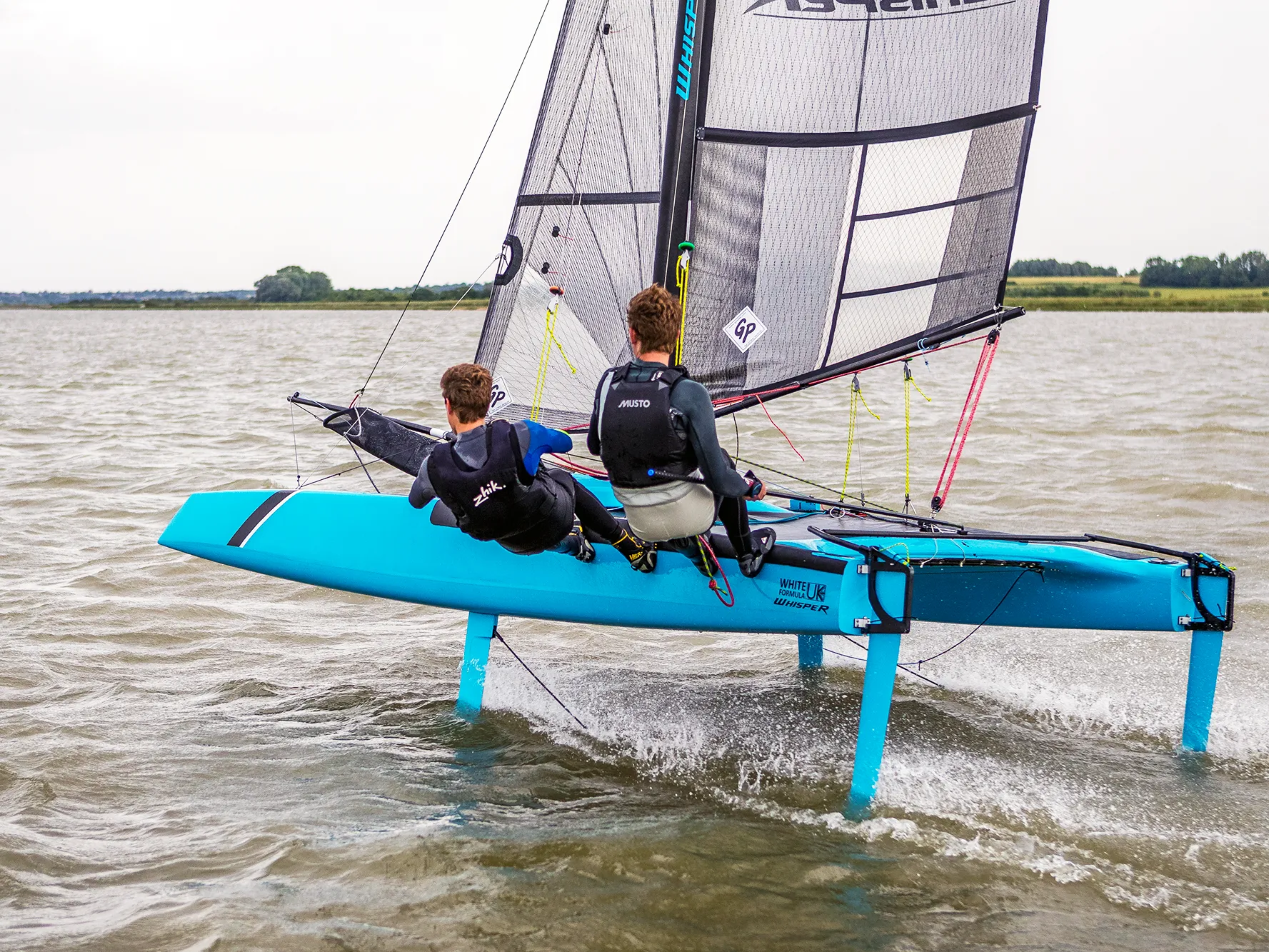 Two sailors aboard a WhiteFormula Whisper foiling dinghy lifting onto foils during racing