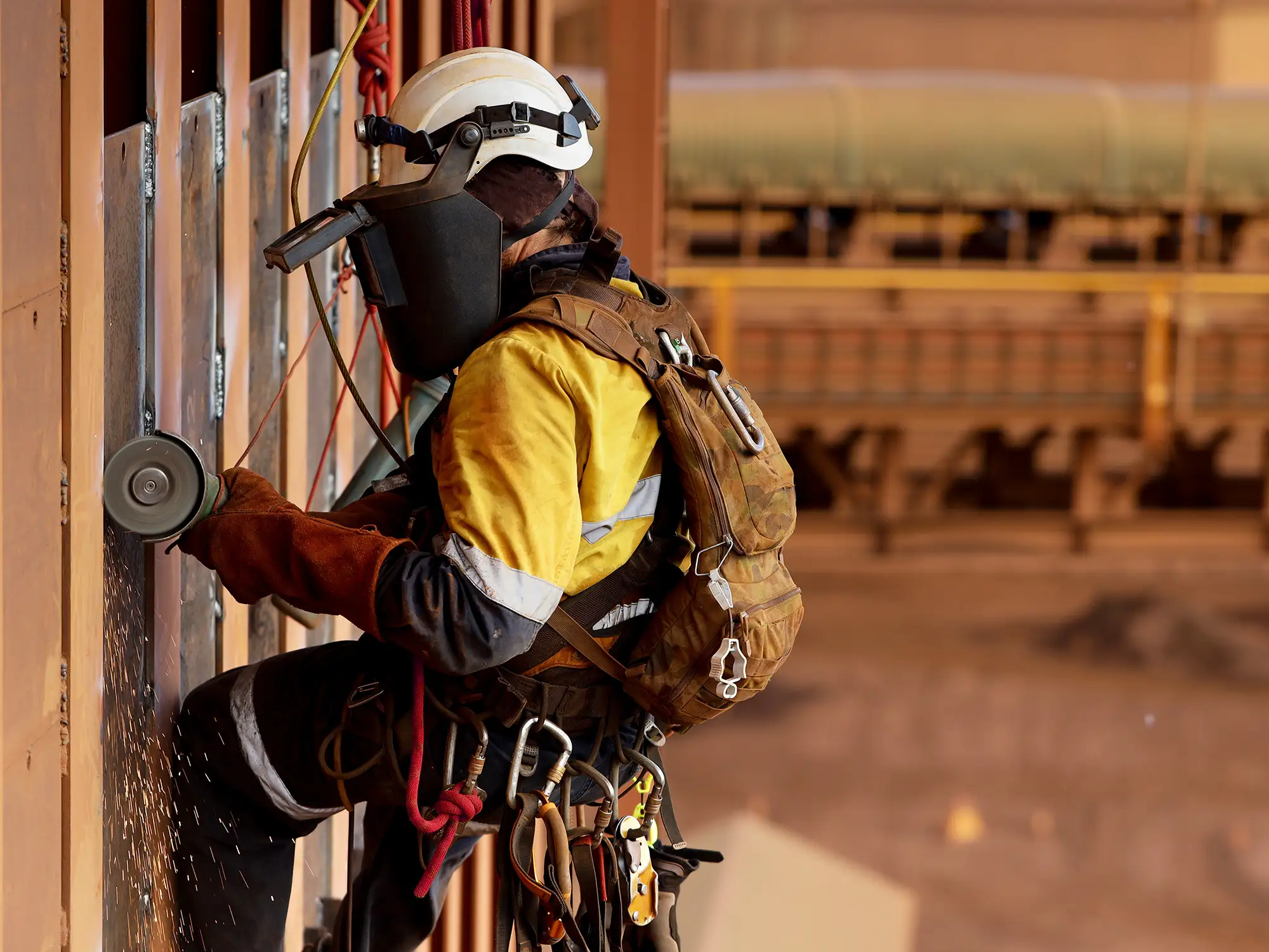 Rope access technician grinding steel near Tutus Firex heat resistant aramid static rope